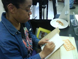 Elaine C. Oldham sketching at Free Comic Book Day
